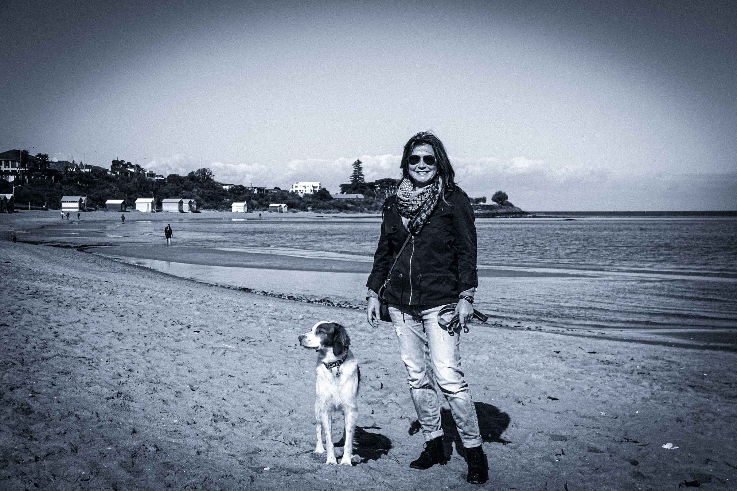 Tina Wendel, founder of Clued, with her dog Max at a Melbourne beach.